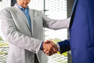 Business people shaking hands in the modern office finishing successful meeting