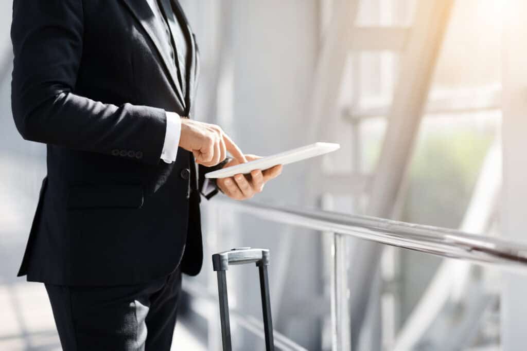 Unrecognizable entrepreneur with digital tablet in airport